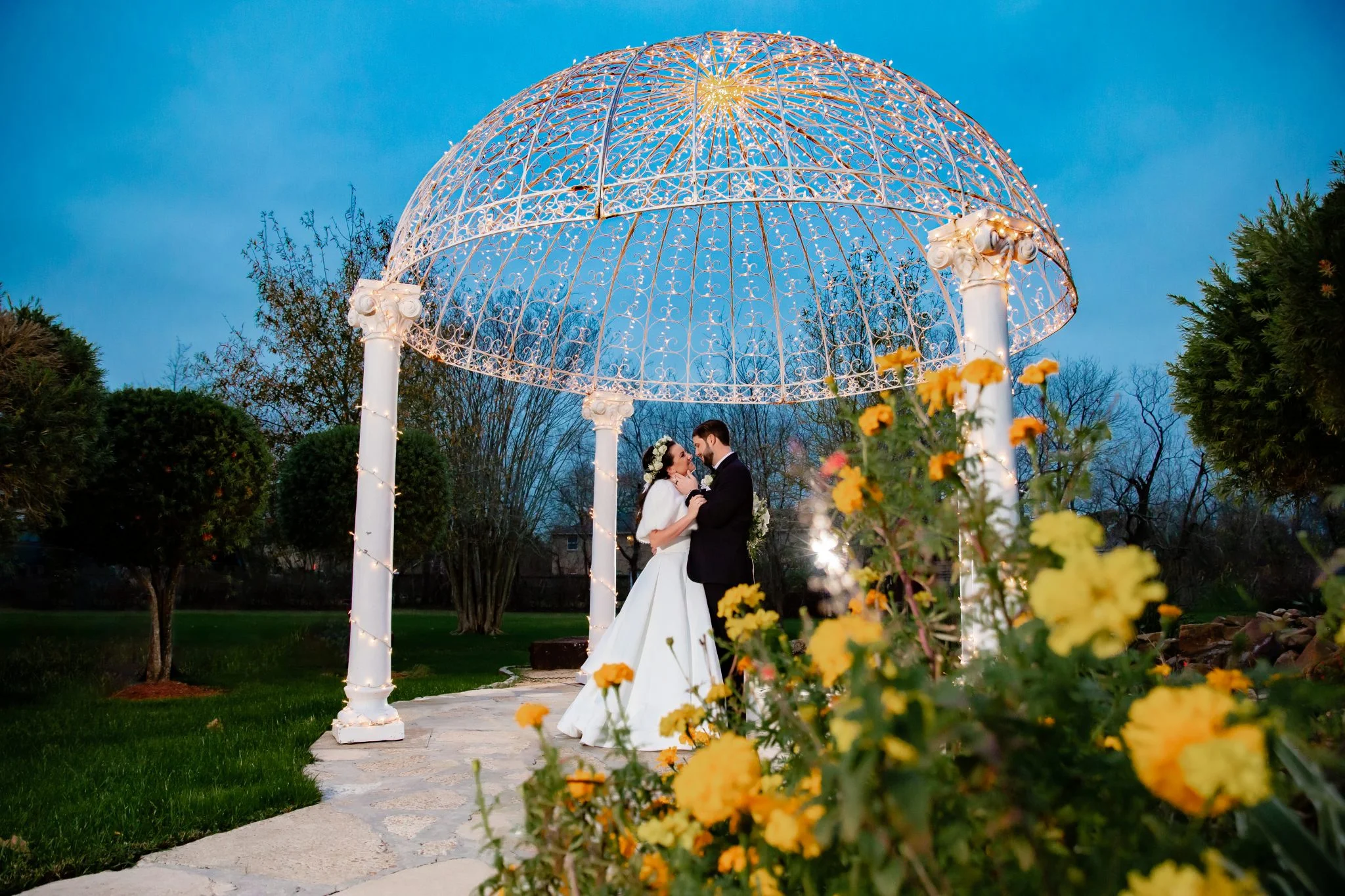 MariKate and Collin under the lit dome at blue hour