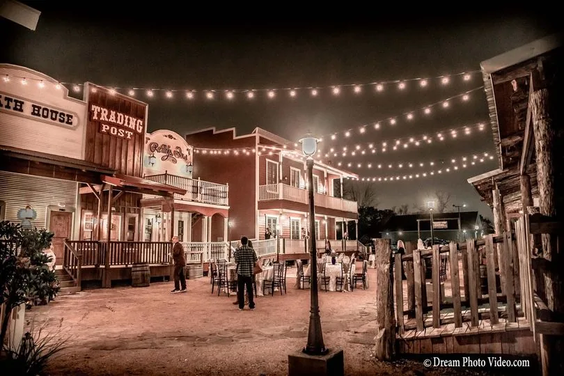 Couple dancing at night under the Sycamoreville string lights
